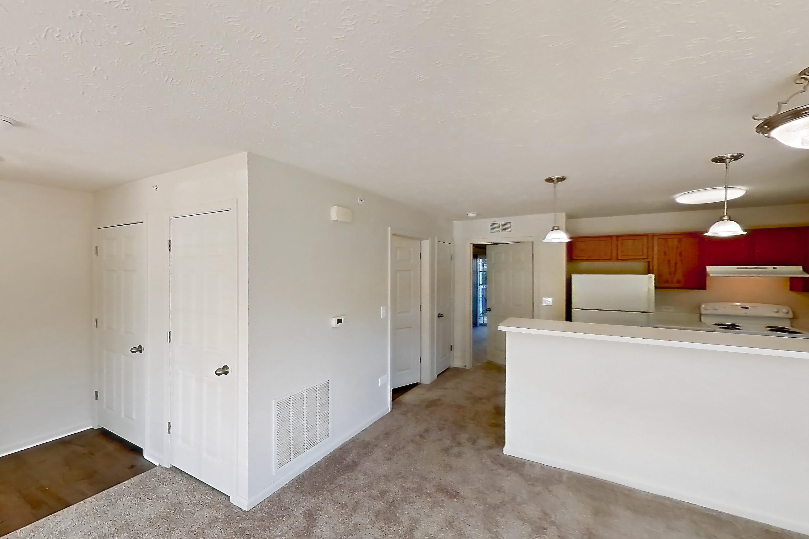 Living room with light carpet, oven/range, refrigerator, and white appliances, Apartment 418 at Village Park
