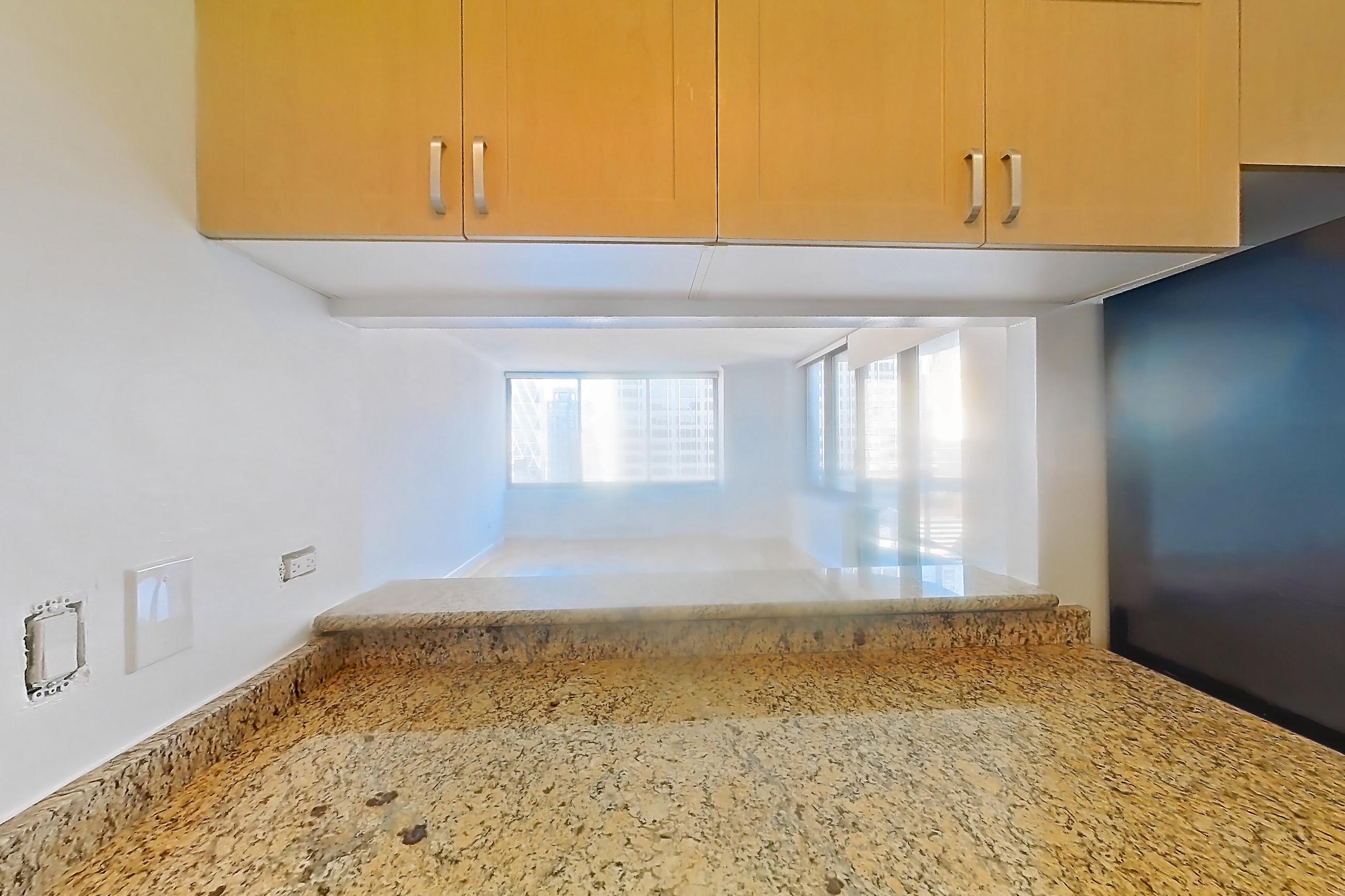 Kitchen with dishwasher, gas range, light stone countertops, light tile flooring, microwave, oven/range, refrigerator, and stainless steel appliances, Apartment 36M at Stonehenge Leasing