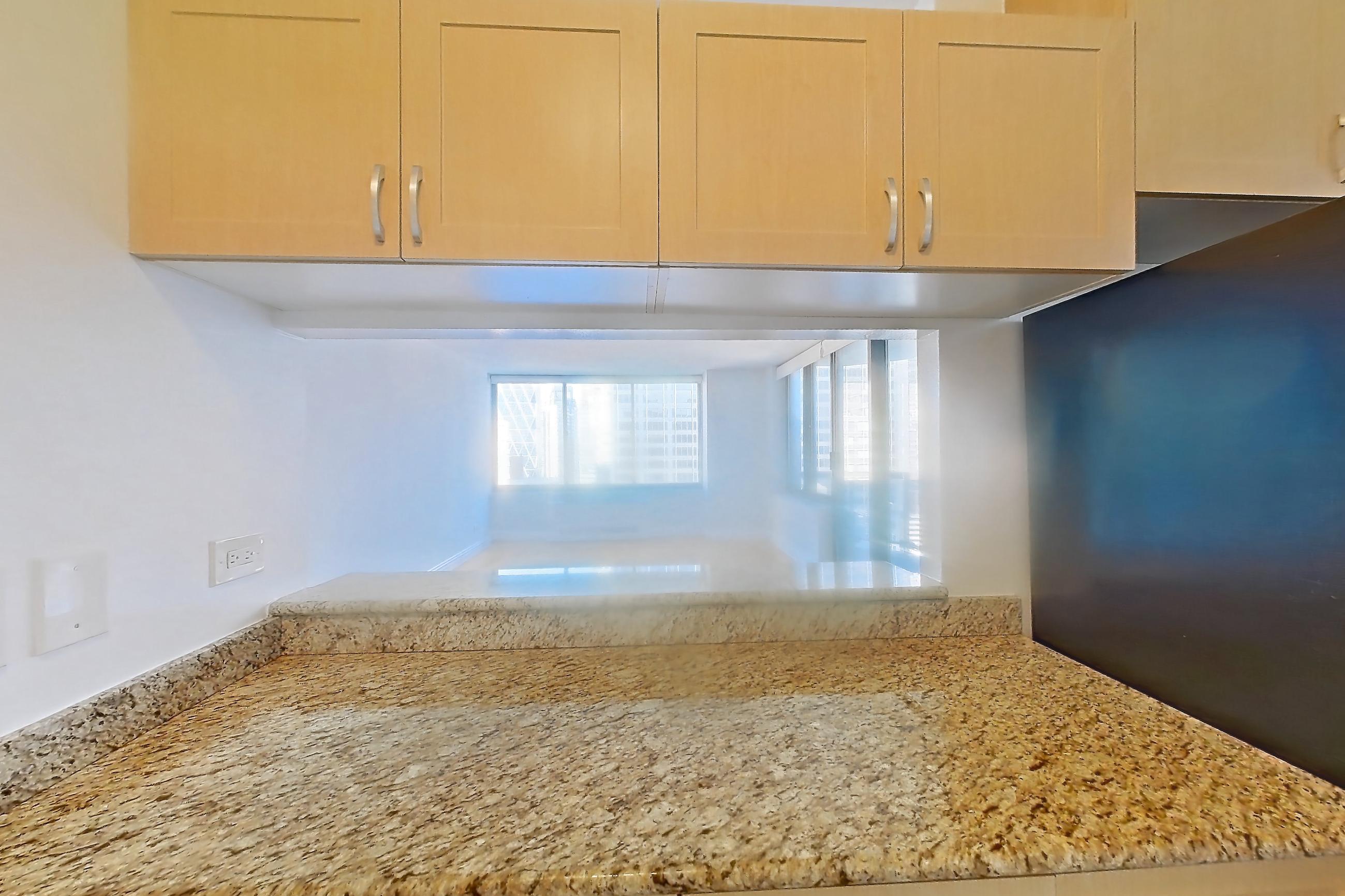 Kitchen with dishwasher, gas range, light countertops, light stone countertops, light tile flooring, microwave, oven/range, refrigerator, and stainless steel appliances, Apartment 35M at Stonehenge Leasing