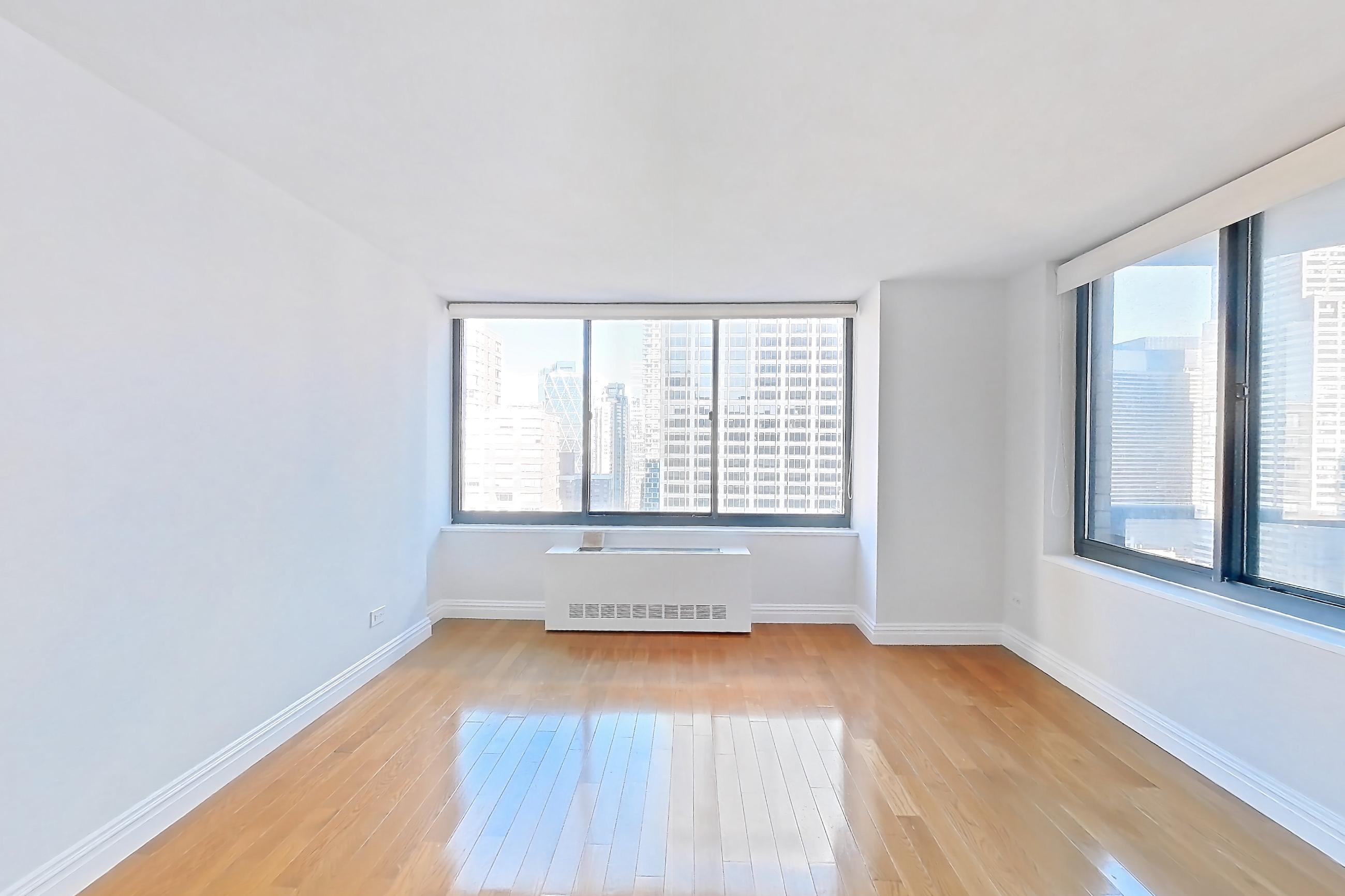 Living room with light wood-finish flooring and wood-finish flooring, Apartment 35M at Stonehenge Leasing