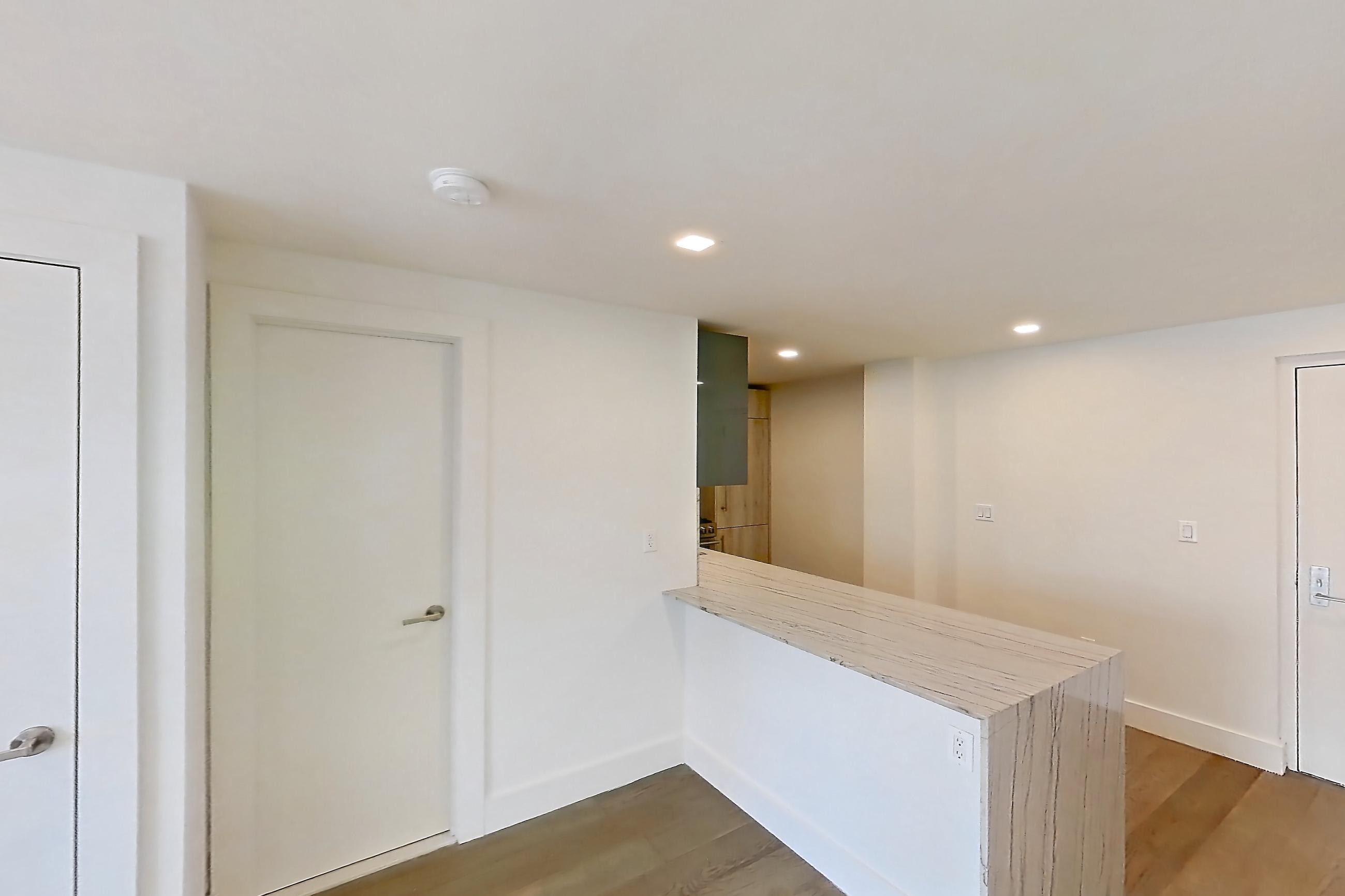 Dining room with air conditioning, baseboard heating, dark wood-finish flooring, and light wood-finish flooring, Apartment 14D at Stonehenge Leasing