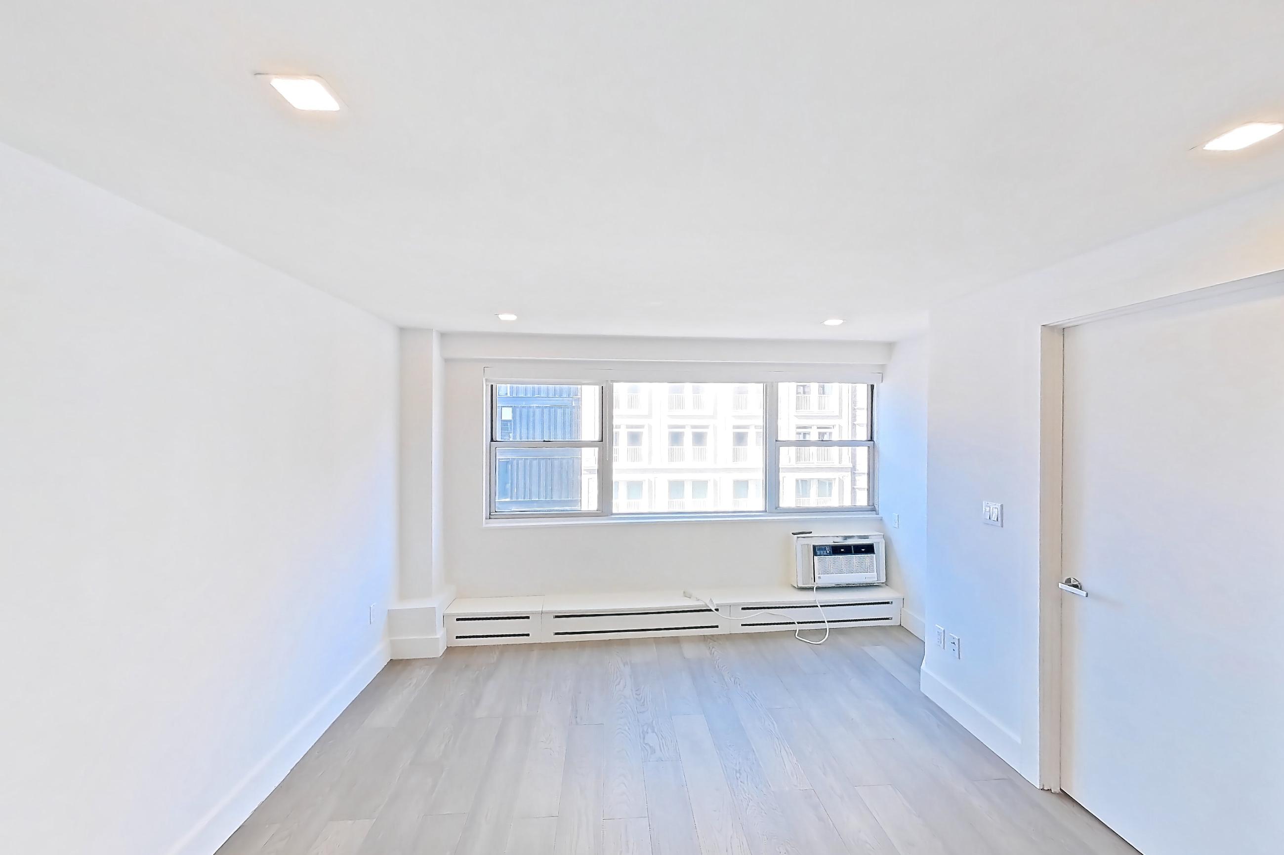 Dining room with air conditioning, baseboard heating, dark wood-finish flooring, and light wood-finish flooring, Apartment 14D at Stonehenge Leasing