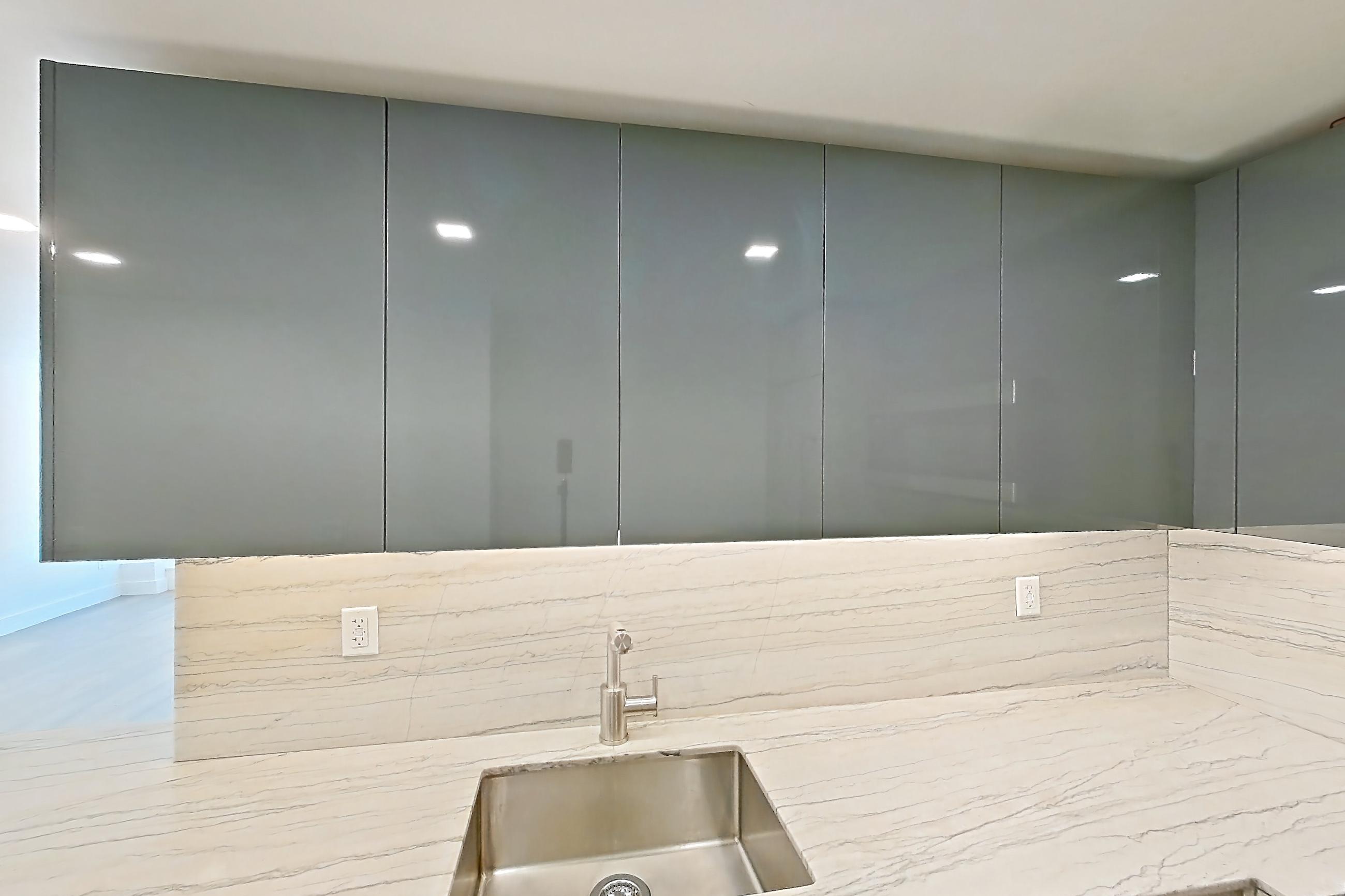 Kitchen with gas range, light countertops, light stone countertops, microwave, oven/range, and stainless steel appliances, Apartment 14D at Stonehenge Leasing