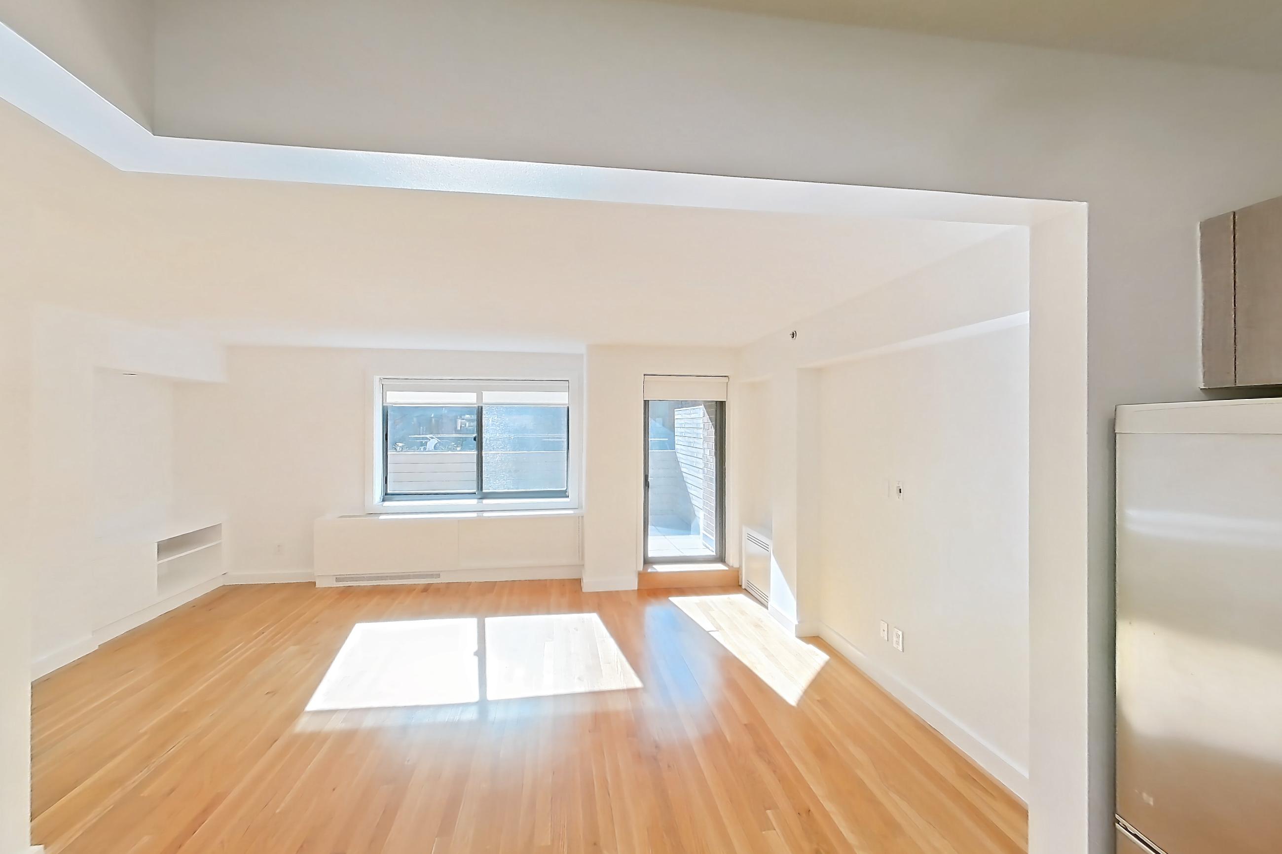 Kitchen with gas range, light countertops, light wood-finish flooring, oven/range, refrigerator, and stainless steel appliances, Apartment 110 at Stonehenge Leasing