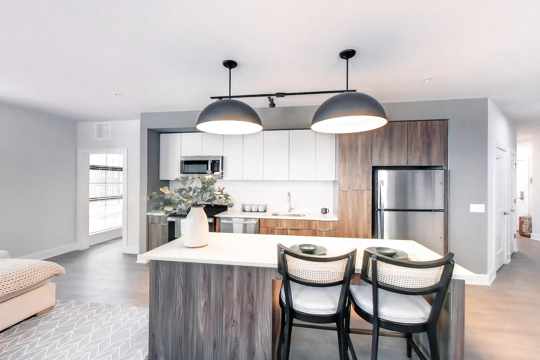 Dining room with dishwasher, electric range, light wood-finish flooring, microwave, oven/range, and stainless steel appliances, Apartment L3 Model at Rye House
