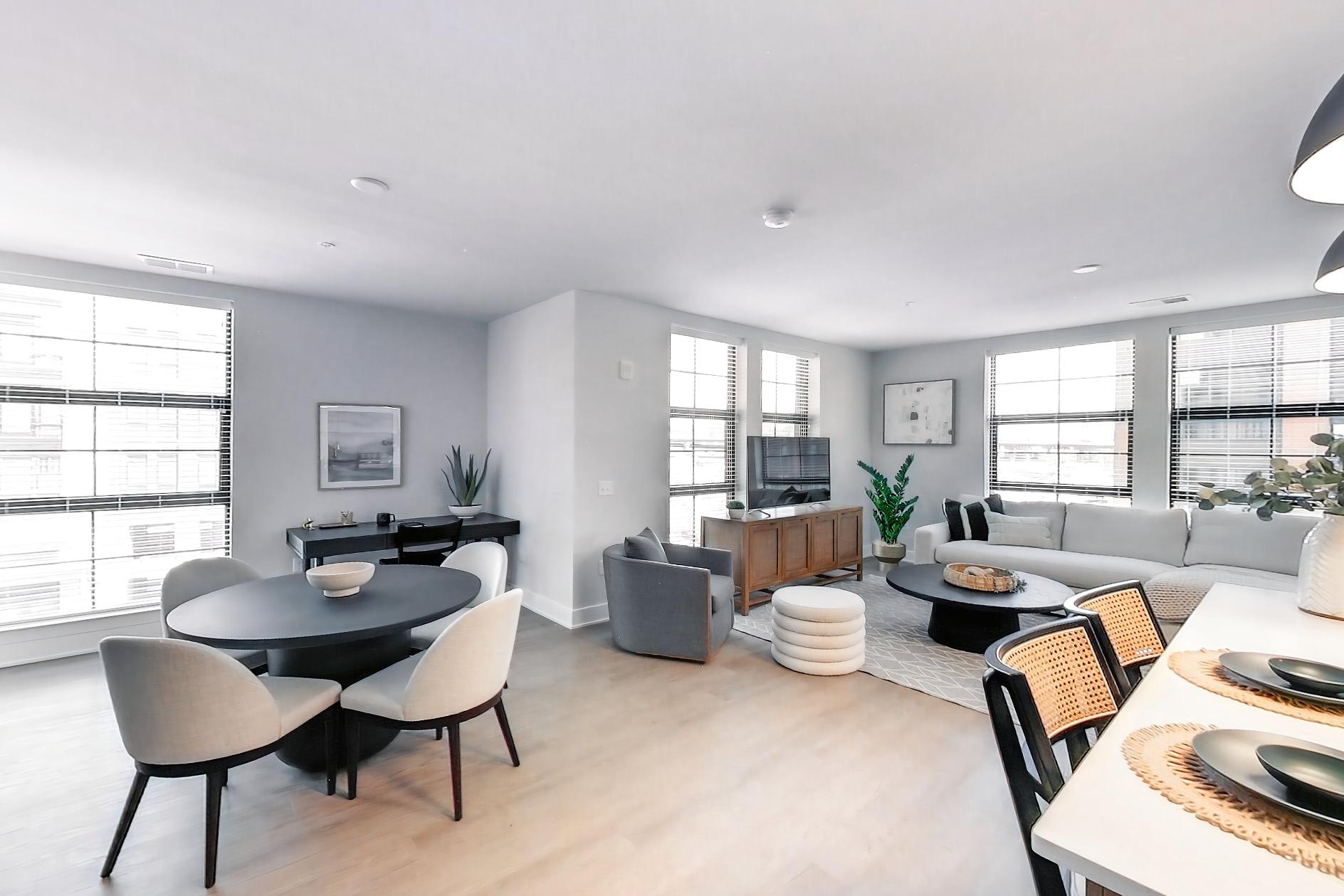 Kitchen with dishwasher, electric range, light stone countertops, light wood-finish flooring, oven/range, refrigerator, and stainless steel appliances, Apartment L3 Model at Rye House