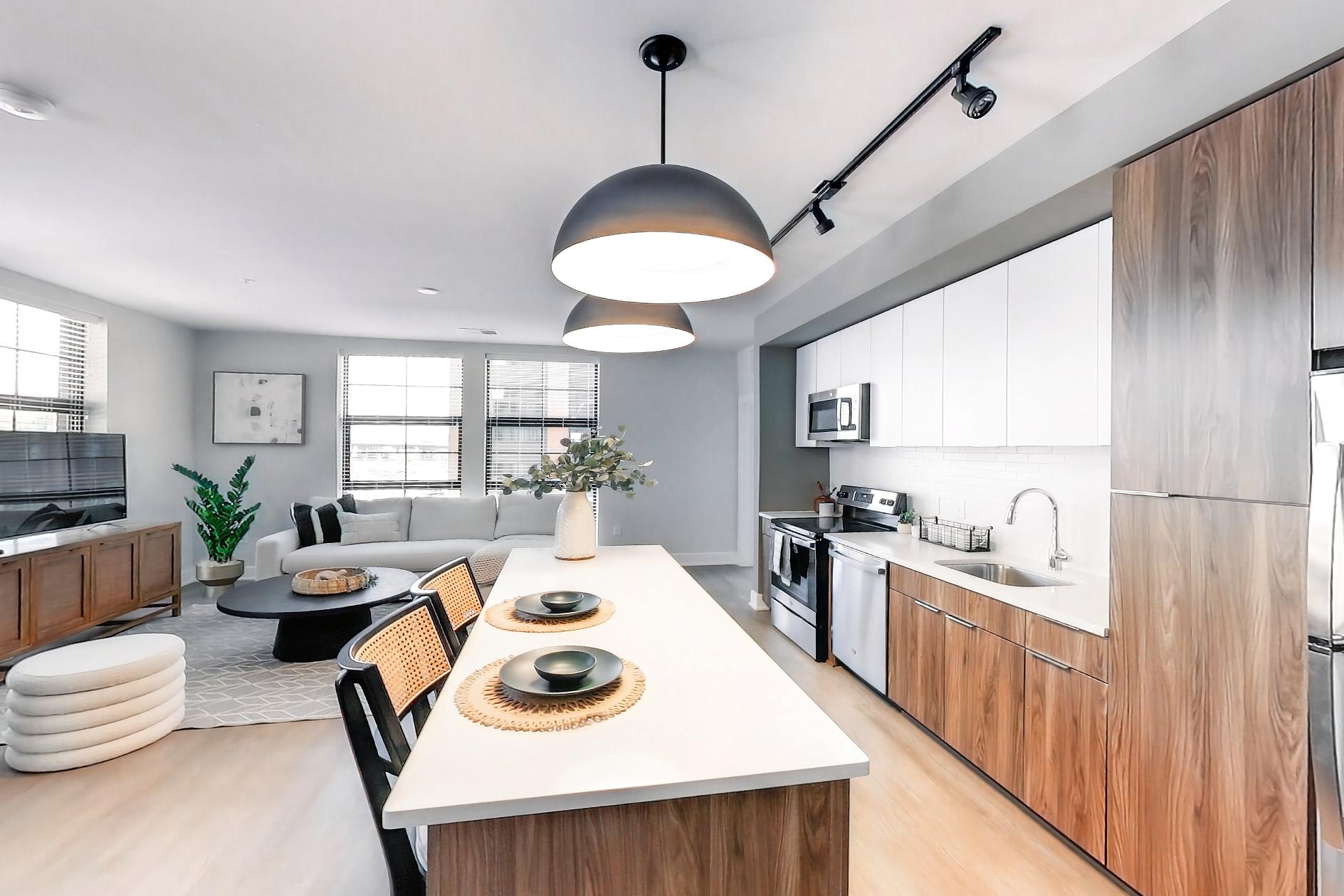 Kitchen with dishwasher, electric range, light stone countertops, light wood-finish flooring, oven/range, refrigerator, and stainless steel appliances, Apartment L3 Model at Rye House