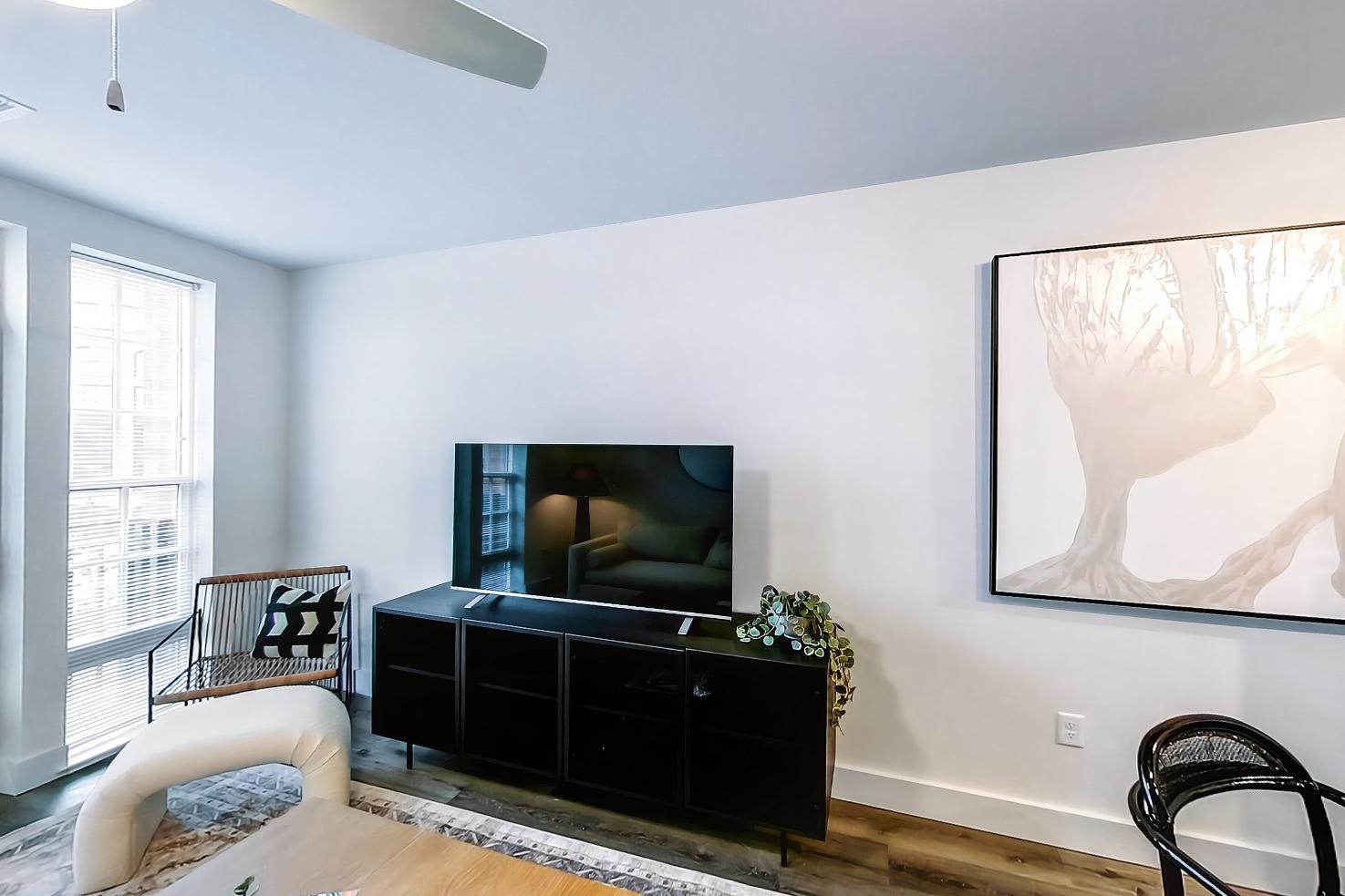 Living space side with dark wood-finish flooring and light wood-finish flooring, Apartment Model at 250 Mission