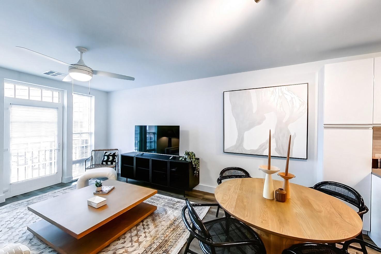Living space with dark wood-finish flooring, electric range, light wood-finish flooring, oven/range, and stainless steel appliances, Apartment Model at 250 Mission